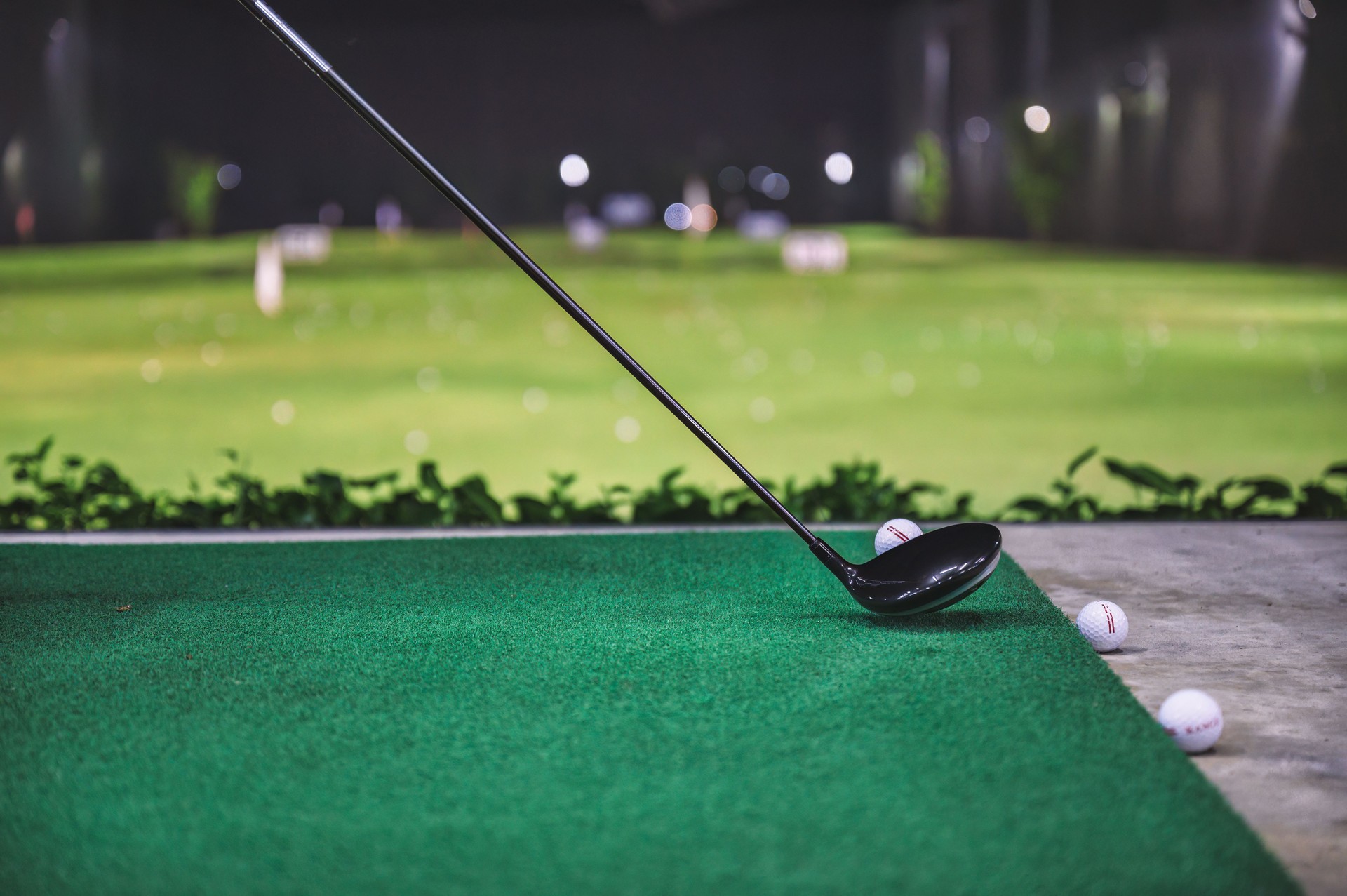 Practicing with golf swing on golf course at golf driving range