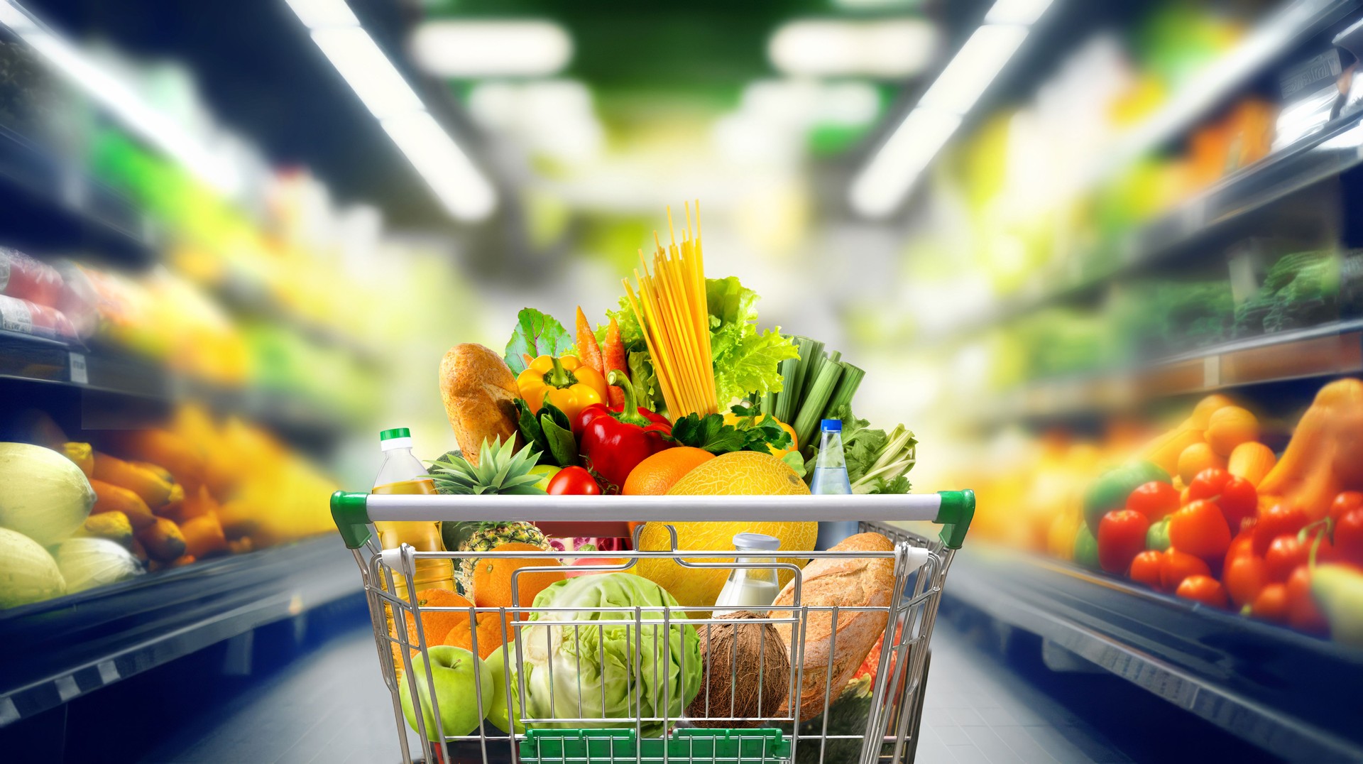 Shopping cart full of groceries at the supermarket.